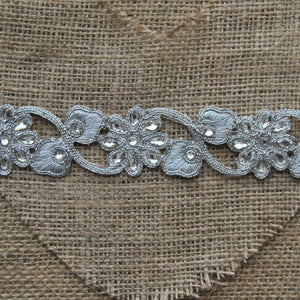 Iron-on Embroidered metallic flower trim with diamante detail.